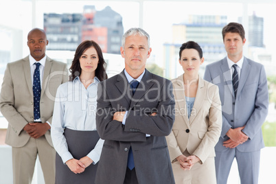 Serious and mature manager crossing his arms in front of his tea