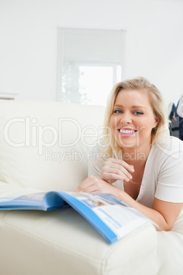 Casual woman reading while she is lying