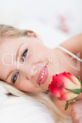 Blue eyed woman with a rose