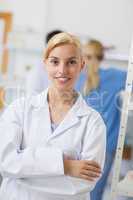 Blonde pharmacist looking at camera with arms crossed