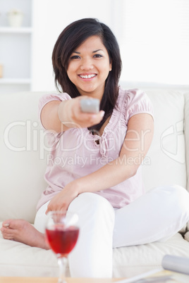 Woman crossing her legs and holding a remote