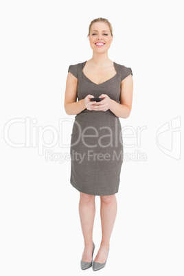 Woman standing with phone in her hands