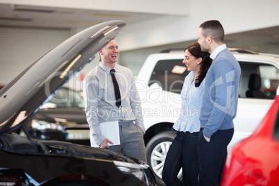 Salesman smiling as he talks to a couple