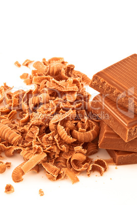 Many chocolate shavings beside a pile of chocolate