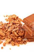 Many chocolate shavings beside a pile of chocolate