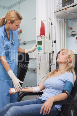Nurse checking a monitor next to a donor