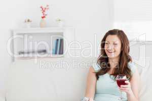 Woman smiling while holding a glass of wine