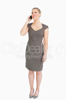 Businesswoman standing while on a phone