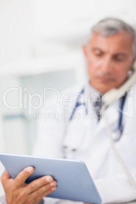 Focus on a doctor holding a tablet computer