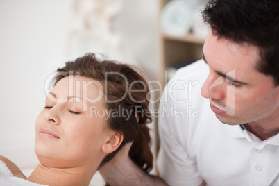 A doctor massaging the head of his patient while holding it