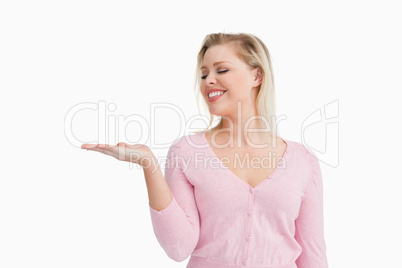 Smiling woman raising her hand palm up