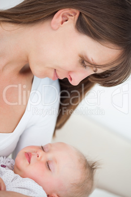 Peaceful brunette woman holding her little daughter