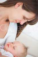 Peaceful brunette woman holding her little daughter