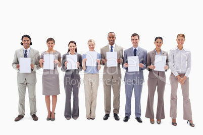 Happy business people holding seven supports for letters