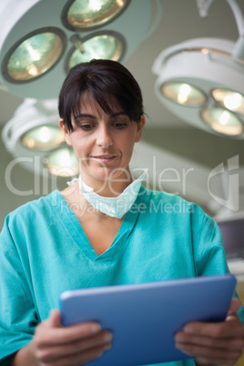 Woman surgeon holding a tactile tablet