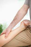 Physiotherapist massaging the leg of a woman