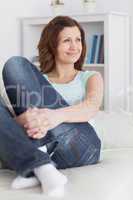 Woman sitting on a sofa while smiling