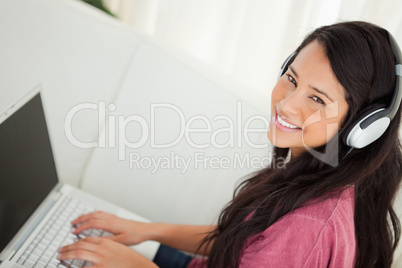 High-angle view of a smiling student using her laptop
