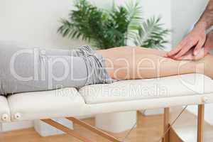 Physiotherapist massaging the legs of a woman