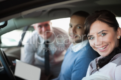 Smiling couple in a new car