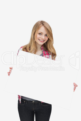 Smiling woman holding a blank board