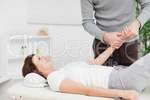 Physiotherapist massaging the hand of a woman