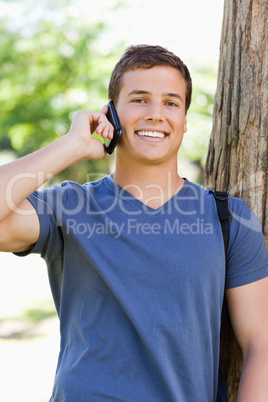 Portrait of a muscled young man on the phone