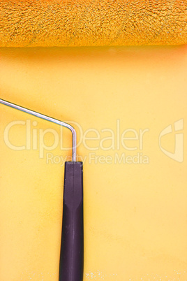 Yellow paint roller handle on a background