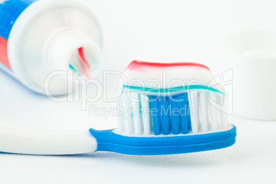 Tube of toothpaste with toothbrush