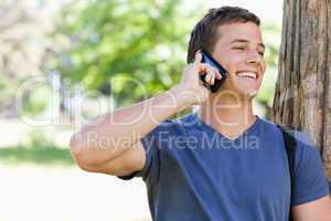 Close-up of a muscled student on the phone