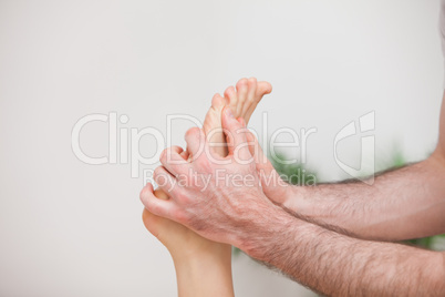 Doctor manipulating the foot of his patient