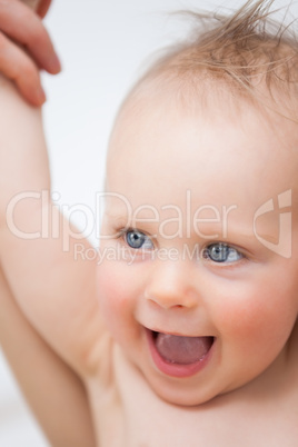 Cute baby laughing while opening her mouth