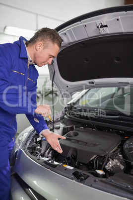 Mechanic showing an engine