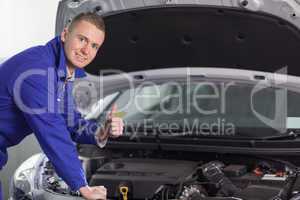 Mechanic looking at camera with his thumb up