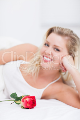 Young woman with a rose smiling