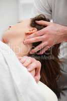 Close-up of chiropractor manipulating the neck of his patient