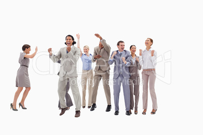Very happy business people jumping and clenching their fists