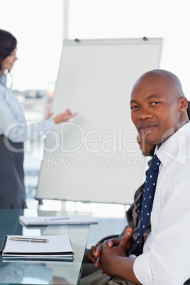Businessman looking at the camera during a presentation given by