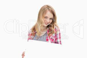 Woman holding a blank board while looking at camera