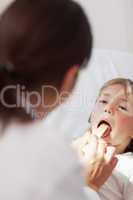 Doctor examining the mouth of a child