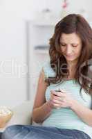 Woman sitting using a mobile phone