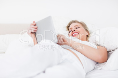 Woman laughing while using an ebook reader