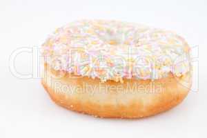 Close up of a doughnut with multi coloured icing sugar