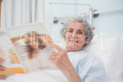 Elderly patient reading a magazine