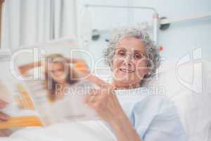 Elderly patient reading a magazine