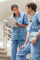 Nurse holding a notepad on stairs