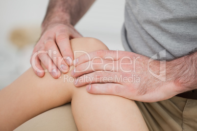 Close-up of a physiotherapist massaging a knee