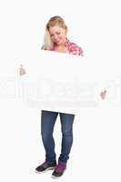 Smiling blonde woman looking at a placard