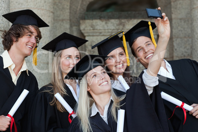 Close-up of five graduates taking a picture of themselves