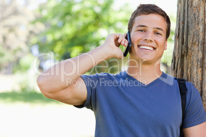 Close-up of a muscled young man on the phone